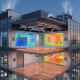 Cross-section of smart building showing HVAC ducts, radiant floor heating, and thermal control systems with blue and orange zones.