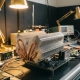Precision-machined aluminum heat sink with copper heat pipes on testing bench surrounded by temperature monitoring equipment