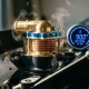 Precision thermostat with metal fins and copper elements mounted on automotive engine block with rising steam and temperature gauge