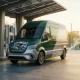 Modern delivery van with cutaway hood showing engine components parked at solar-powered charging station, exhaust vapor transforming into green leaves