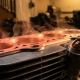 Metal engine block with heat distortion waves rising from glowing red-hot cylinders and stress fractures on aluminum cooling fins