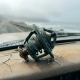 Corroded automotive thermostat with green-blue oxidation on weathered dashboard, ocean spray droplets and salt crystals visible