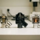 Three thermostat housings in stainless steel, black polymer, and brushed aluminum showing internal components on white lab surface