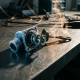 Precision thermostat valve split open on brushed steel workbench, frost crystals beside heat shimmer, industrial lab setting with dramatic side lighting.